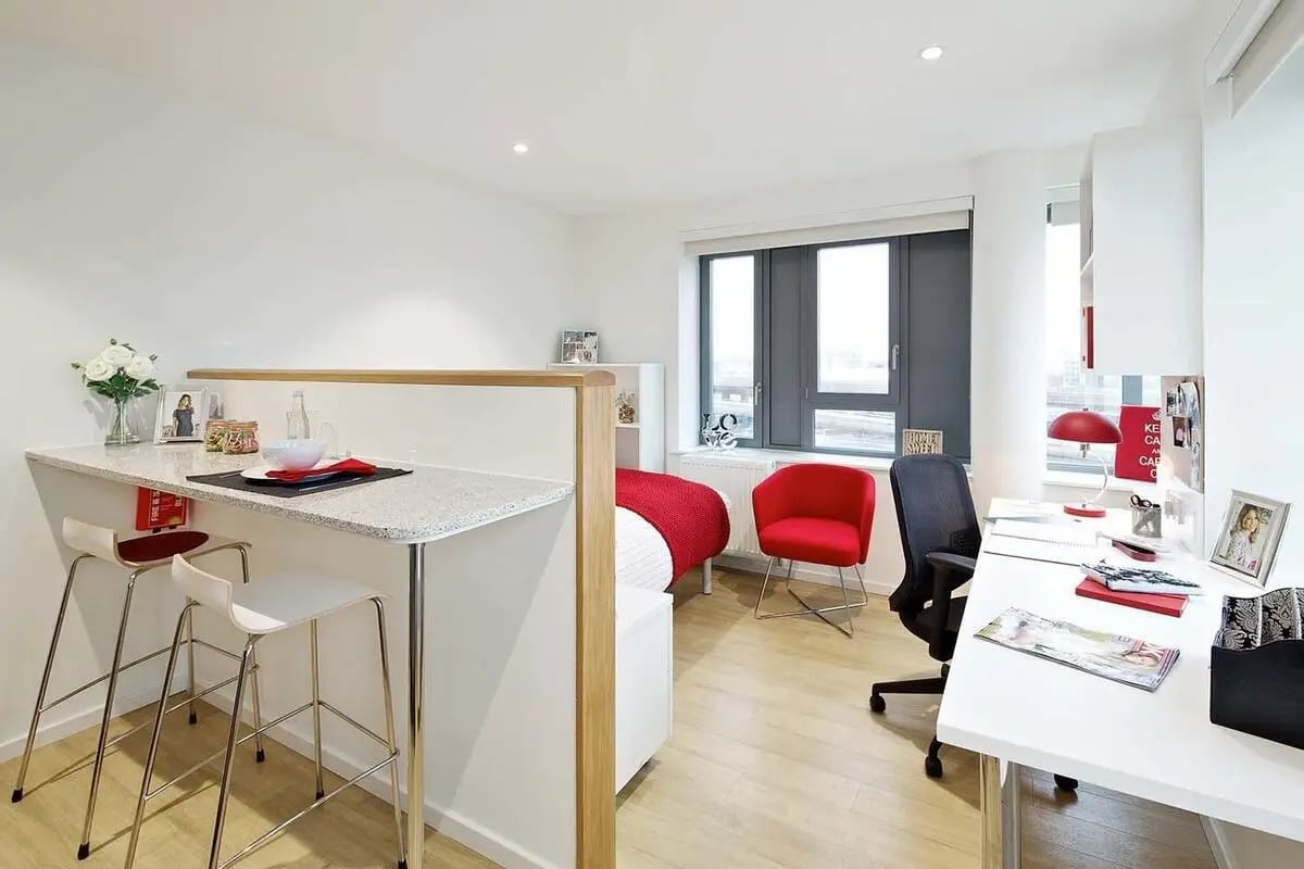 Kitchenette and study area with bar stools and desk Bedroom at Wood Lane Studios in London Student Accommodation