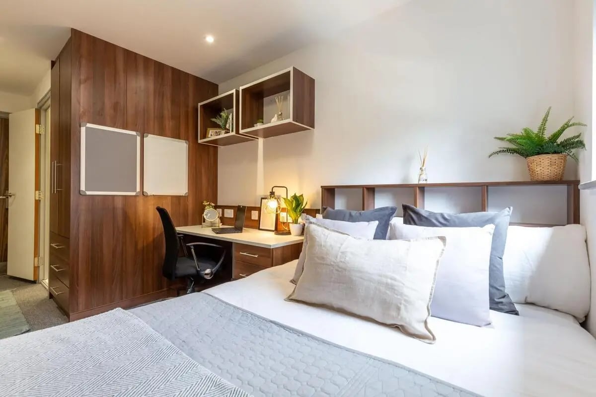 Bed desk chair whiteboards shelves plant bedroom at The Foundry in Leeds Student Accommodation