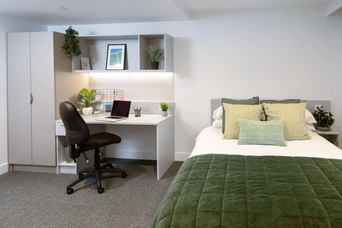 Desk with laptop chair and bed bedroom at True Sheffield in Sheffield Student Accommodation