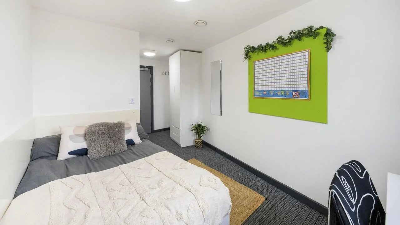 Bed wardrobe calendar and plant bedroom at Glassworks - Liverpool in Liverpool Student Accommodation