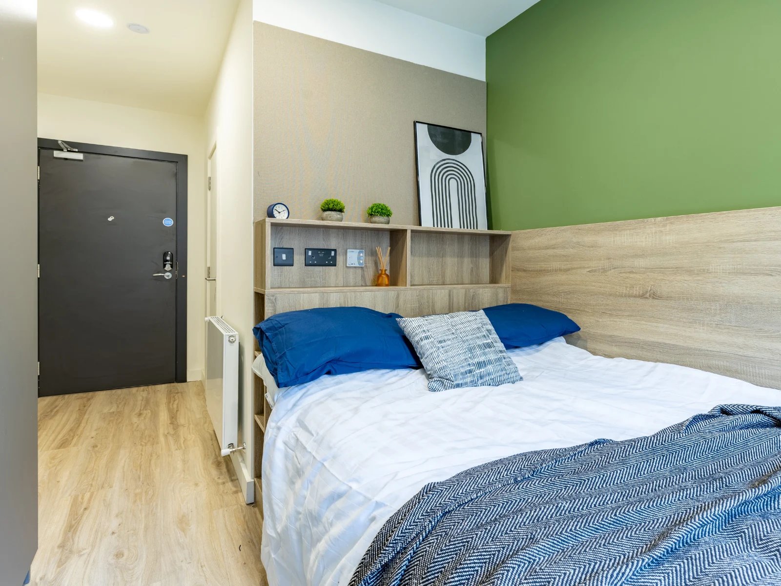 Bed with blue pillows and patterned throw bedroom at Ardee Point in Dublin Student Accommodation