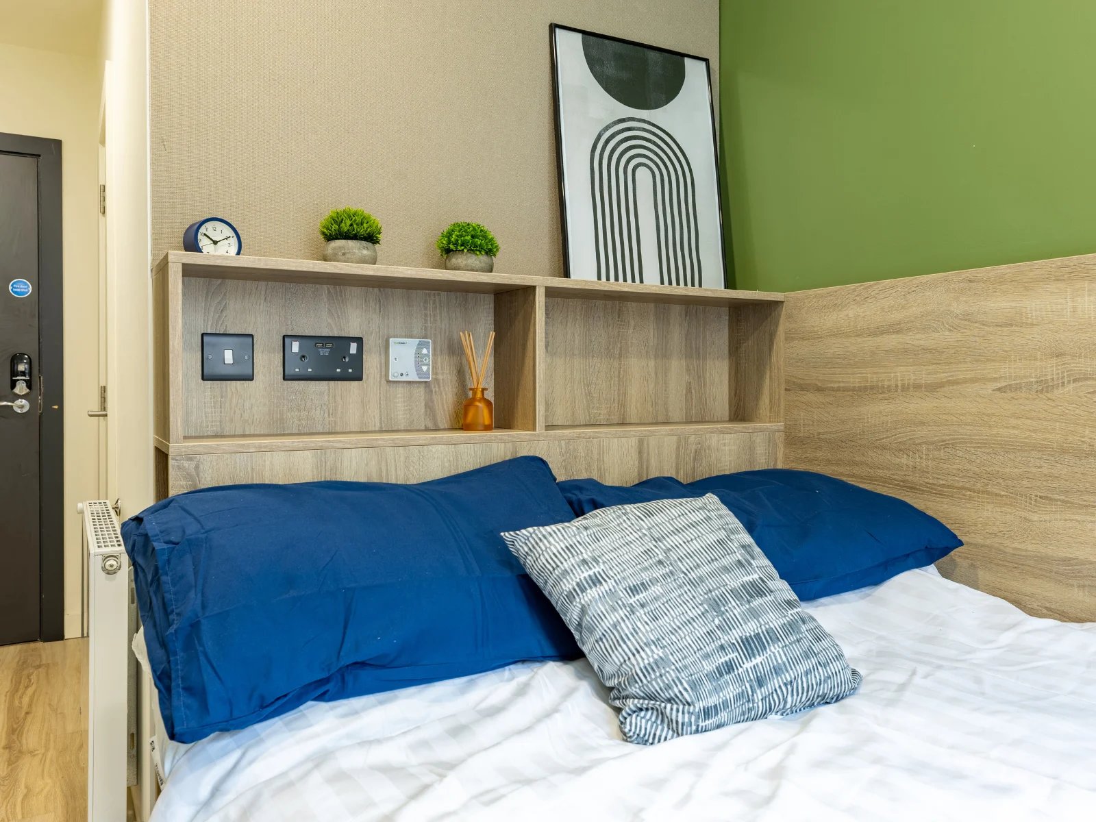 Bed with blue pillows and modern art bedroom at Ardee Point in Dublin Student Accommodation
