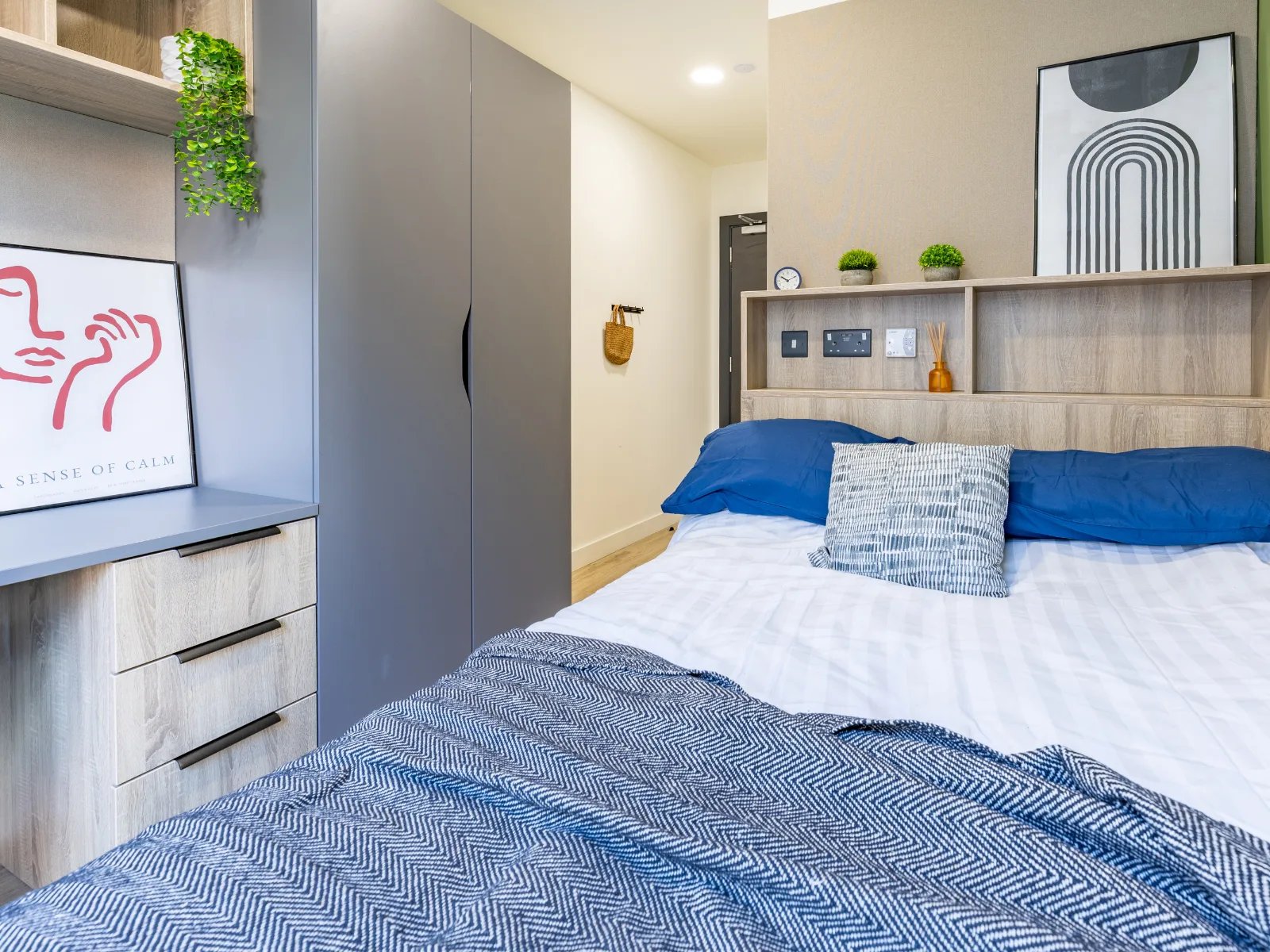 Bed with blue pillows and patterned throw Bedroom at Ardee Point in Dublin Student Accommodation