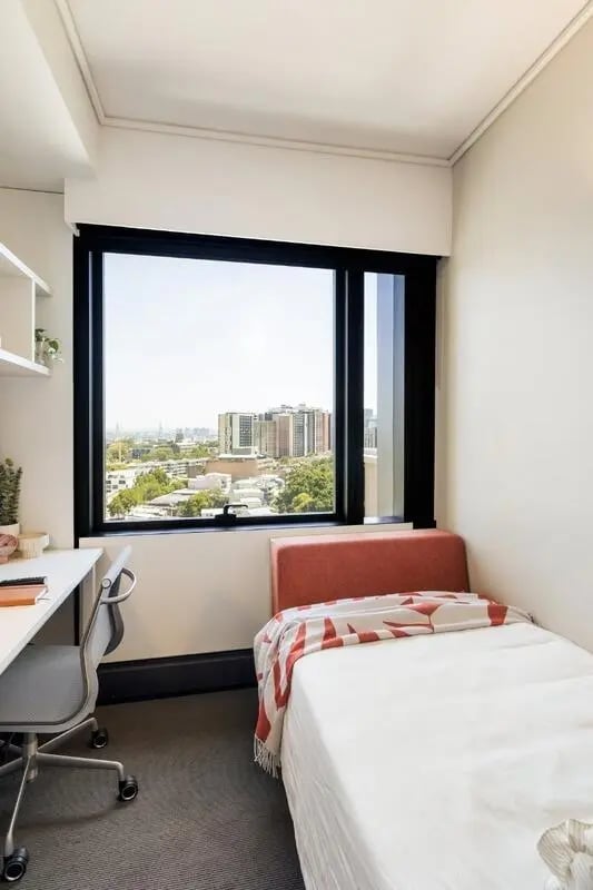 Desk chair bed and blanket bedroom at Iglu Waterloo in Sydney Student Accommodation