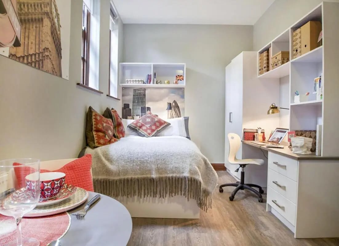 Bed desk chair and shelving unit bedroom at Halsmere Studios in London Student Accommodation
