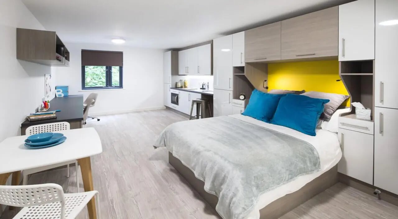 Bed desk kitchen and dining student studio at St Giles Studios in Durham Student Accommodation