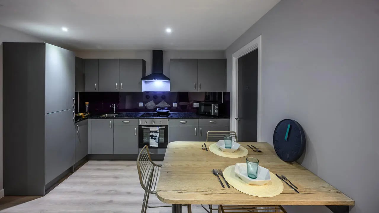 Modern grey kitchen with dining table and chairs kitchen at Carters Yard in Stirling Student Accommodation