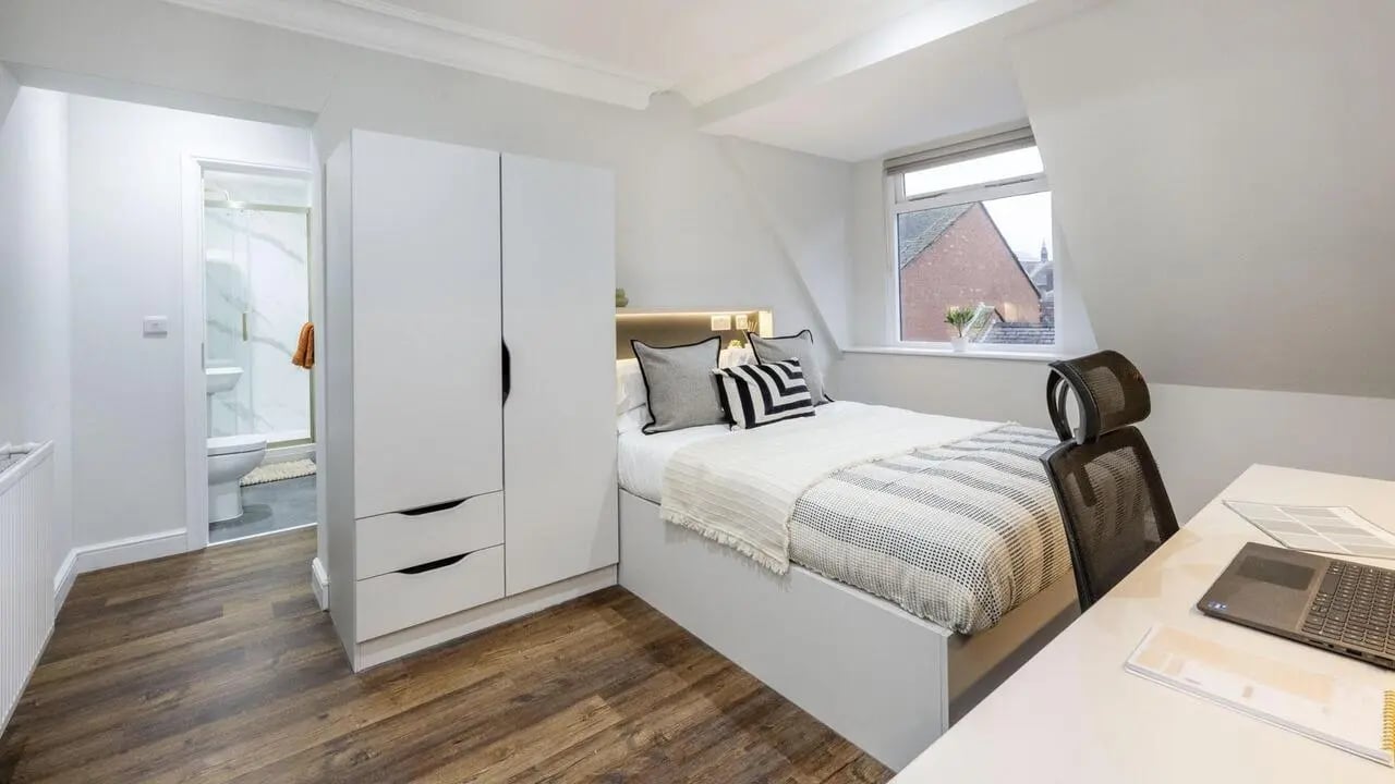 Bed wardrobe desk and bathroom student bedroom at 26 Great George Street in Leeds Student Accommodation