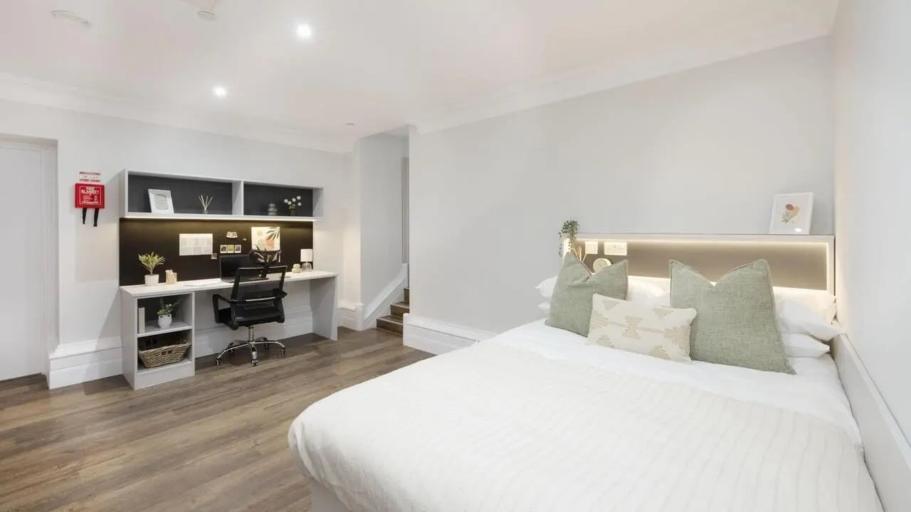 Bed desk chair shelves with decorations bedroom study area at 26 Great George Street in Leeds Student Accommodation