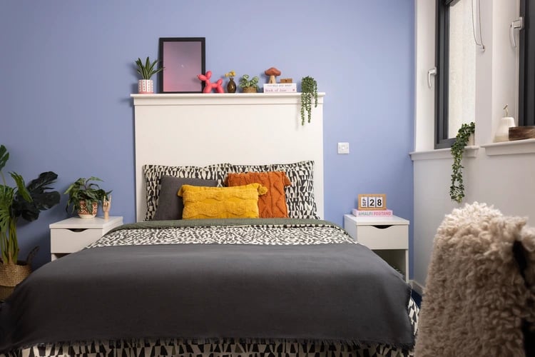Bed with pillows shelf decor and plant bedroom at Shrubhill House in Edinburgh Student Accommodation