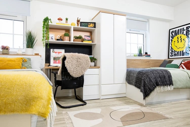 Two beds desk chair wardrobe study area at Walmsley Studios in London Student Accommodation