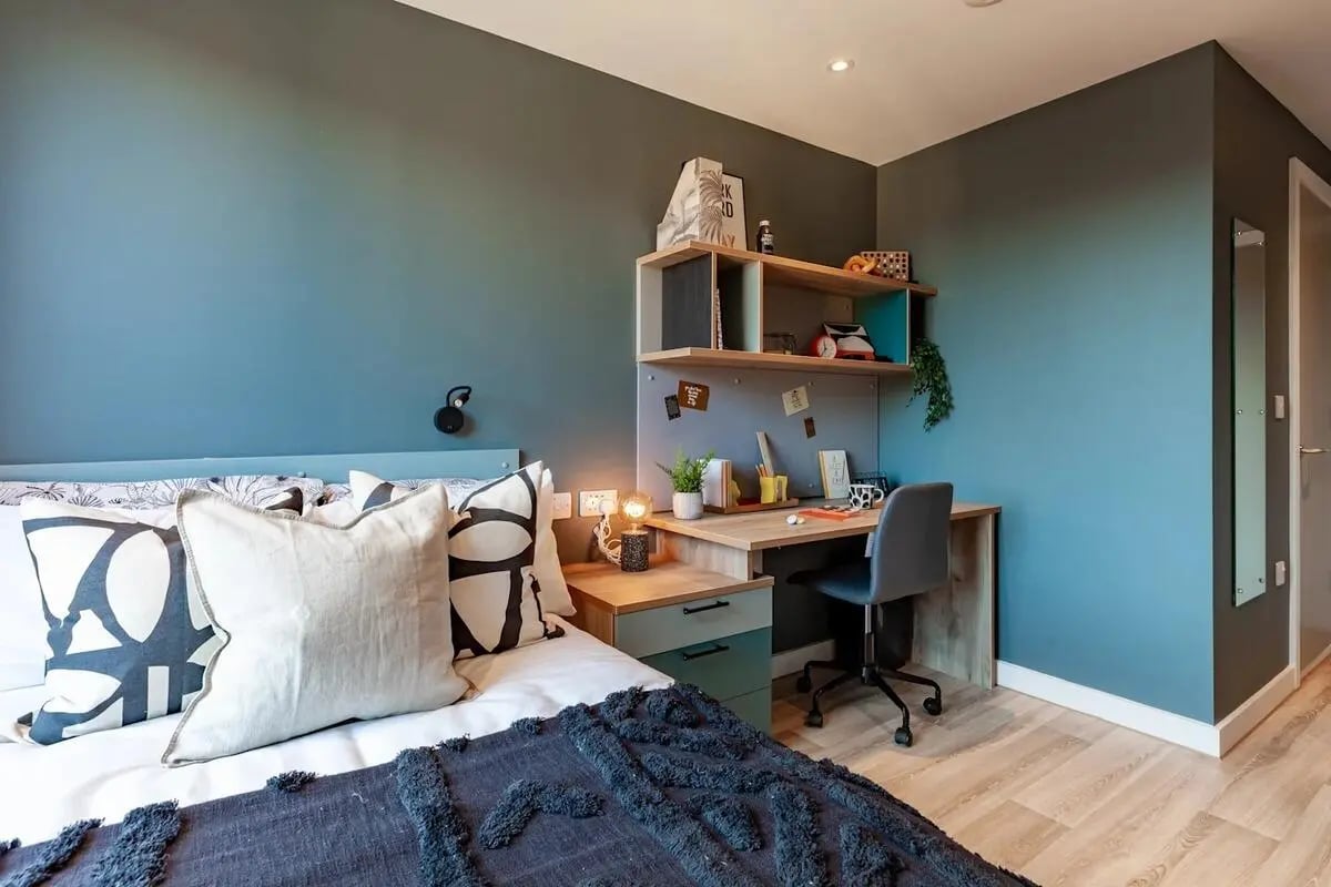 Bed desk chair and shelves bedroom study area at Benson Yard in Liverpool Student Accommodation