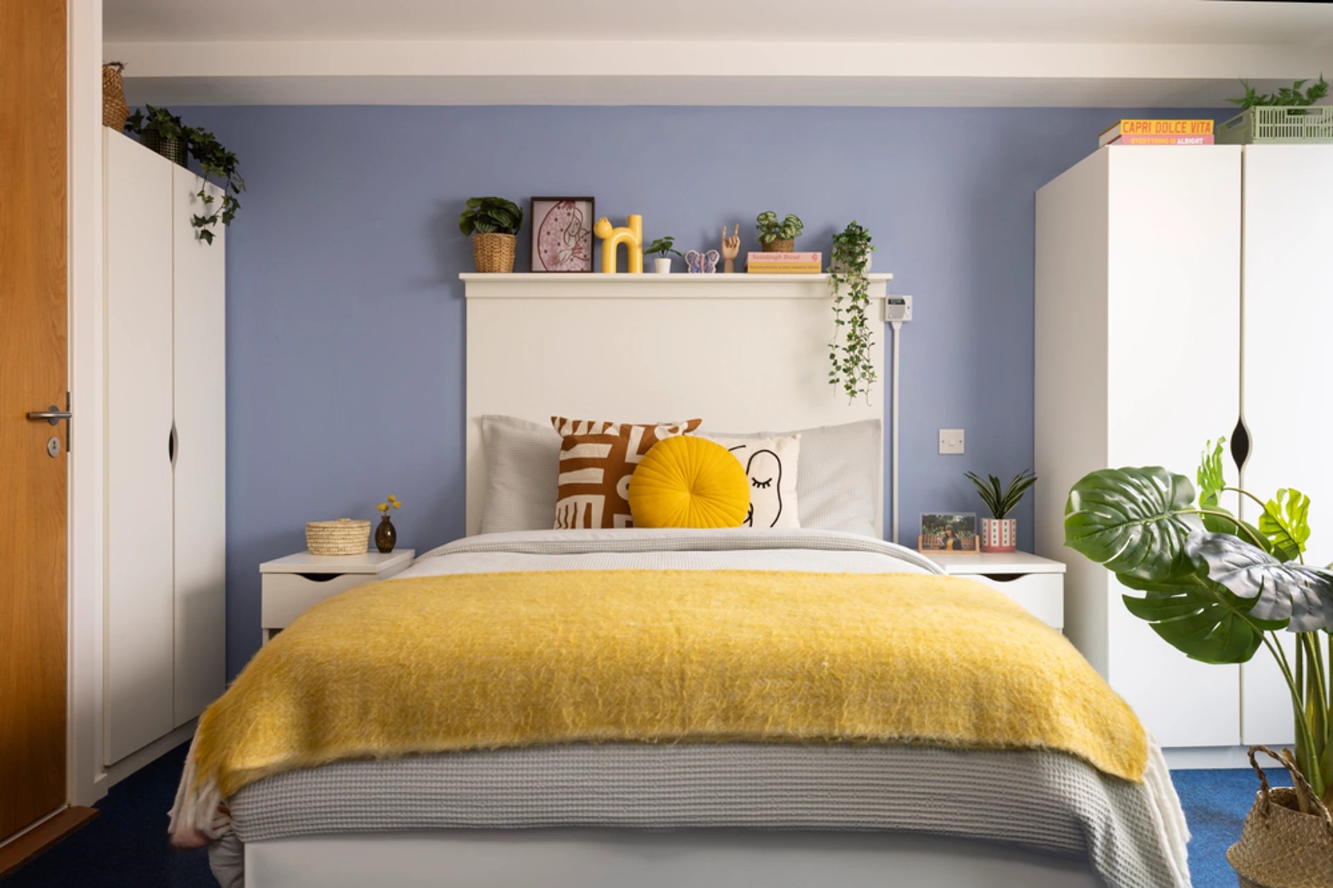 Bed with yellow throw and decorative pillows bedroom at Murano House in Edinburgh Student Accommodation