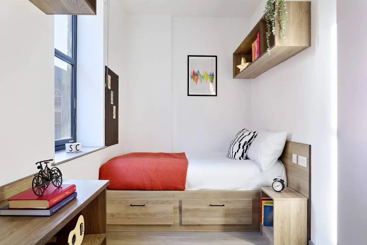 Bed with red throw and bedside table bedroom at Student Castle Reading (New Century Place) in Reading Student Accommodation