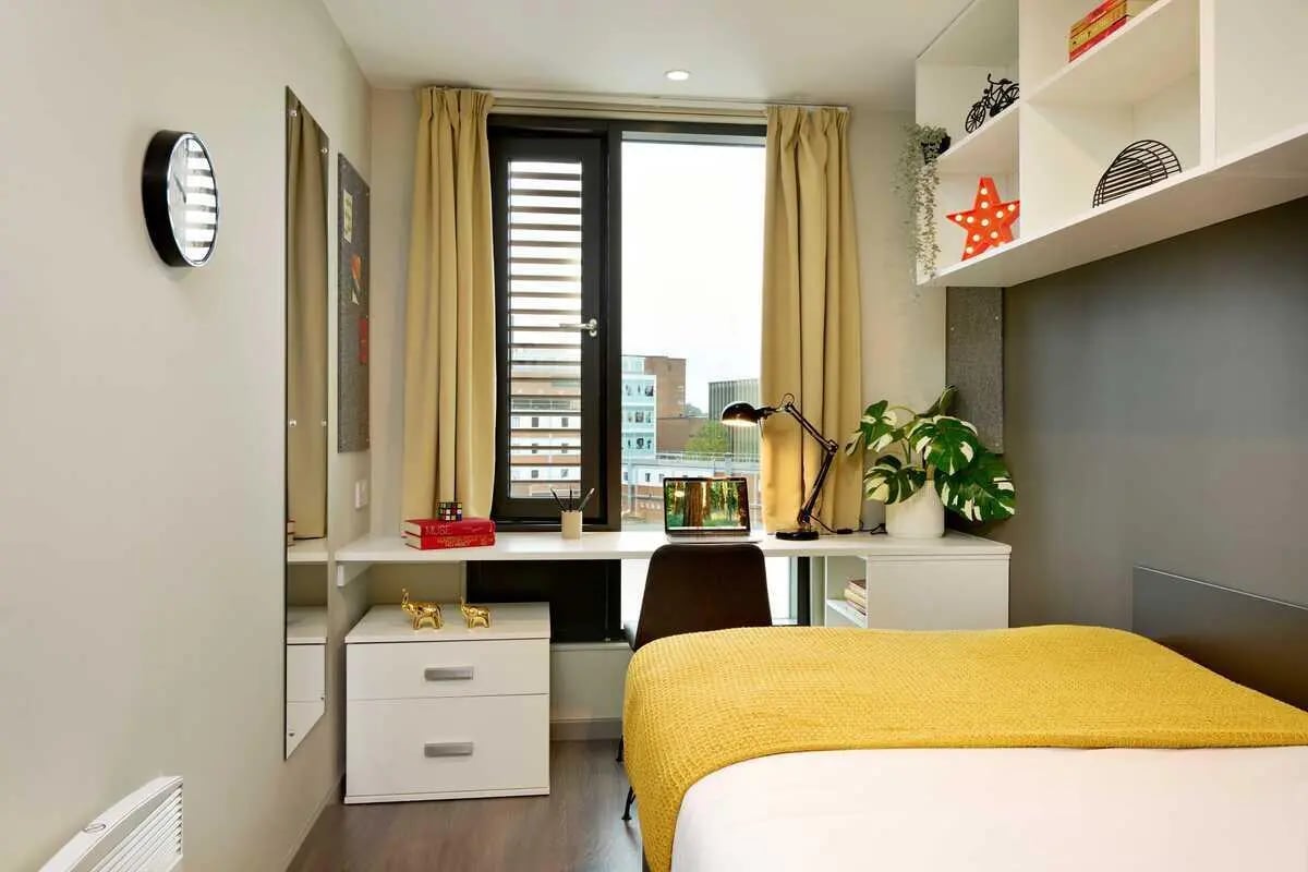 Bed desk lamp shelves and clock bedroom at Millennium View in Coventry Student Accommodation