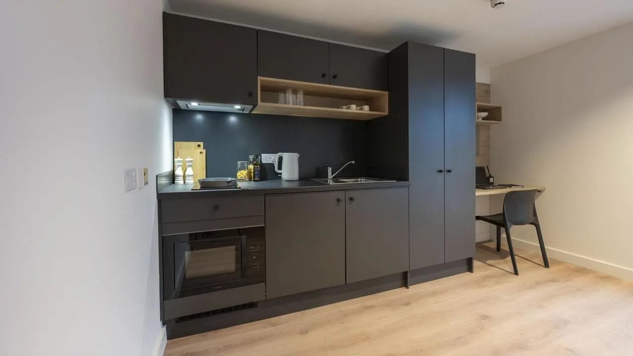 Modern compact kitchen with desk and chair kitchen at Straits Place in Edinburgh Student Accommodation