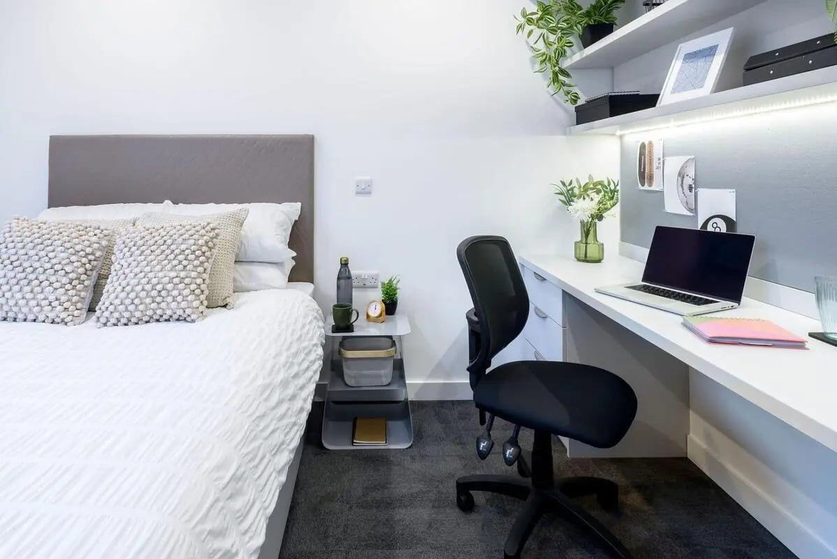 Bed desk chair and laptop bedroom study area at True Swansea in Swansea Student Accommodation