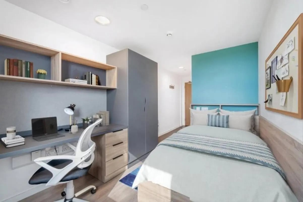 Desk lamp laptop chair shelves bed bedroom at Canvas Walthamstow in London Student Accommodation