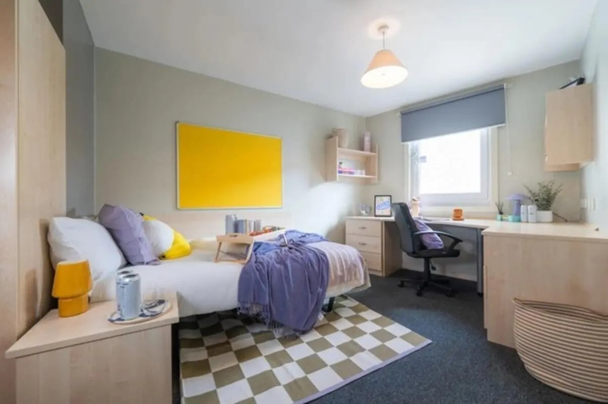 Bed desk lamp pillows tray and rug bedroom at The Heights in Birmingham Student Accommodation