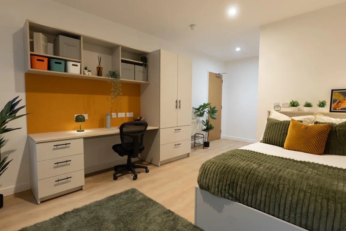 Desk bed wardrobe plants bedroom at Telephone House in Dundee Student Accommodation