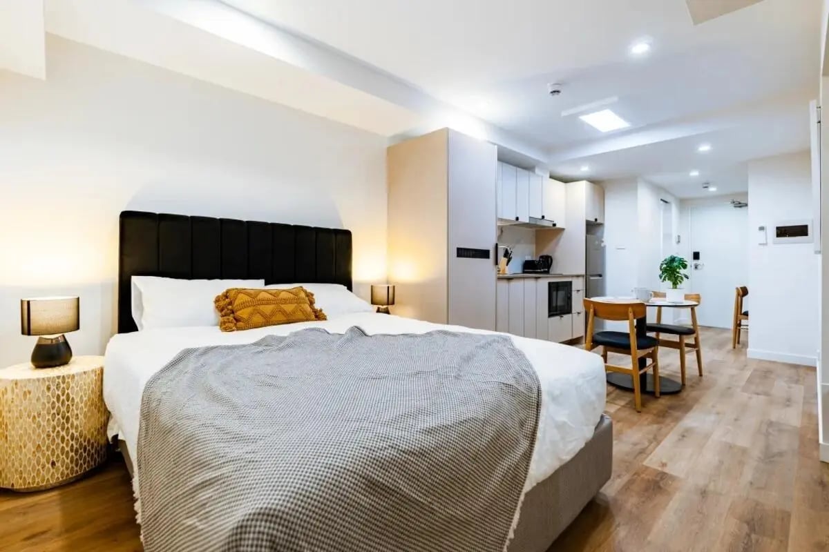 Bed with kitchen table and chairs bedroom at UKO Annandale Tower C in Sydney Student Accommodation