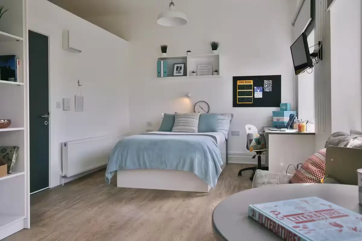 Bed desk shelving and radiator student room bedroom at Claremont House in Glasgow Student Accommodation