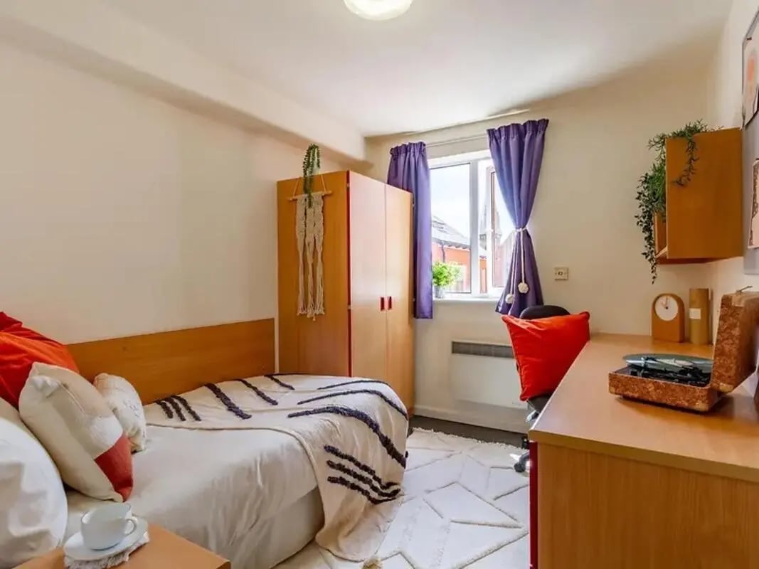 Bed wardrobe desk and chair student bedroom at Yugo Park Court in Lincoln Student Accommodation