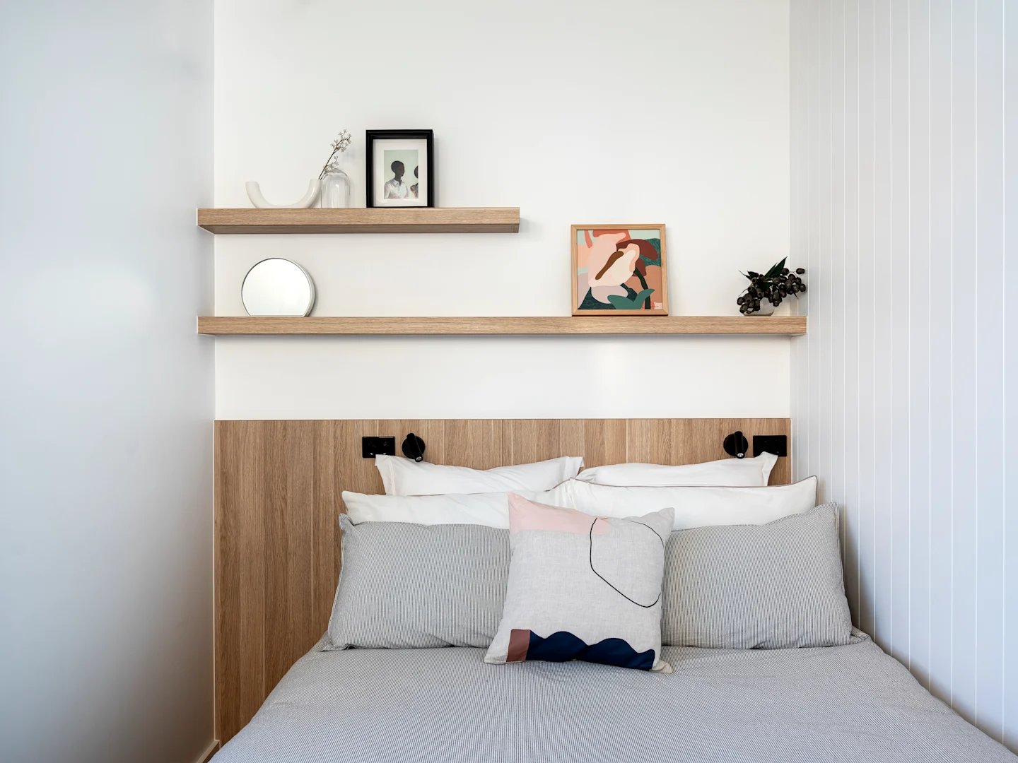Bed with pillows shelves art and mirror bedroom at UKO Glebe in Sydney Student Accommodation
