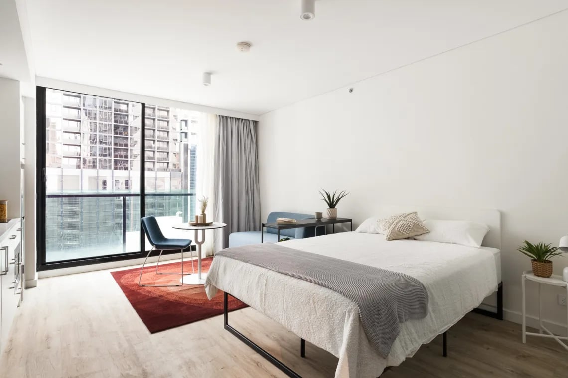 Bed table chair sofa urban view bedroom at UKO Melbourne Central in Melbourne Student Accommodation