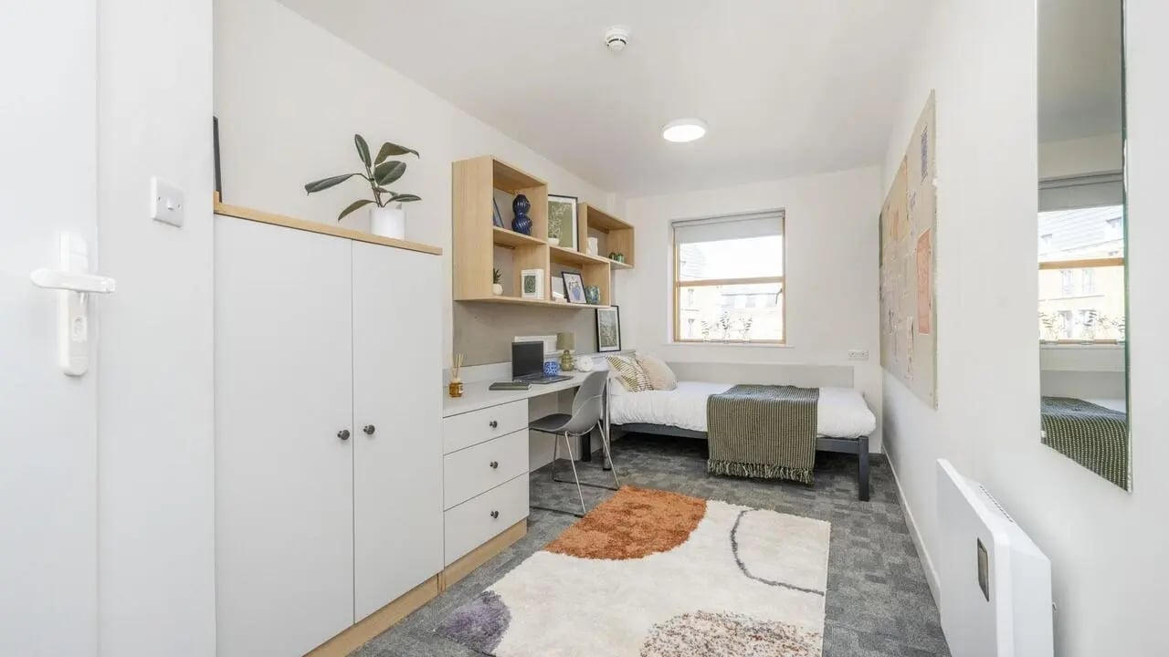 Bed desk closet and shelves bedroom at Abode York in York Student Accommodation