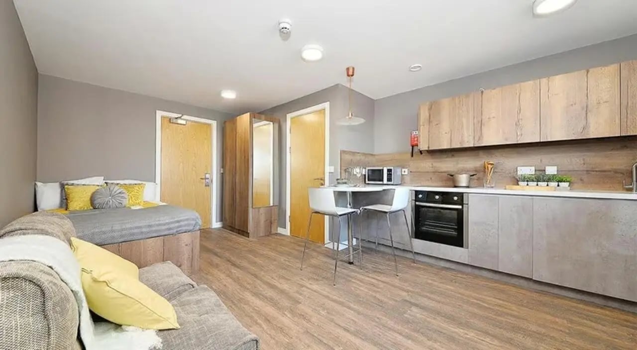 Bed couch kitchen area and microwave studio apartment at 800 Bristol Road in Birmingham Student Accommodation