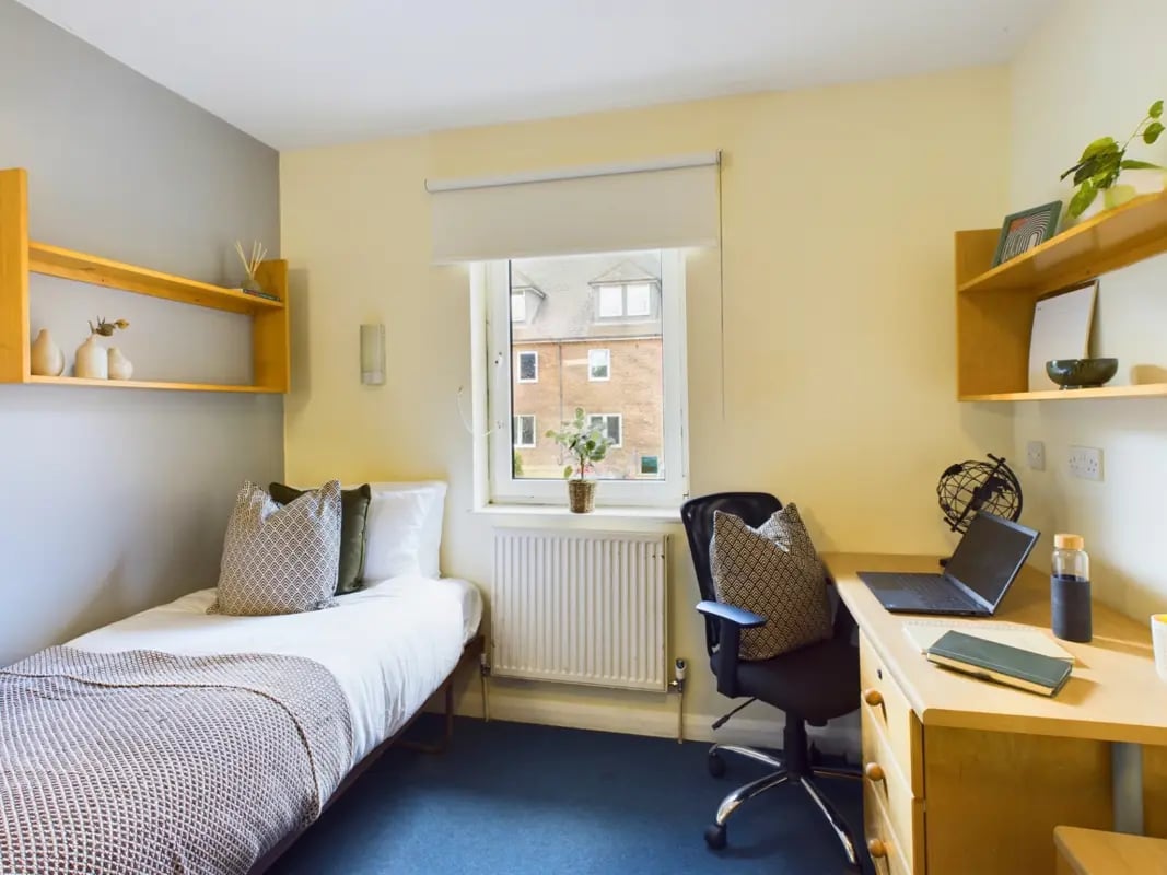 Bed desk shelves and laptop student bedroom at Moulsecoomb Place in Brighton Student Accommodation