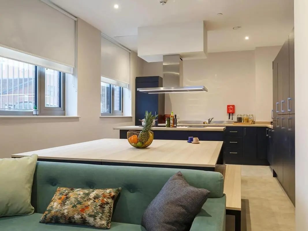 Sofa kitchen island and appliances kitchen area at COSMOS in Sheffield Student Accommodation