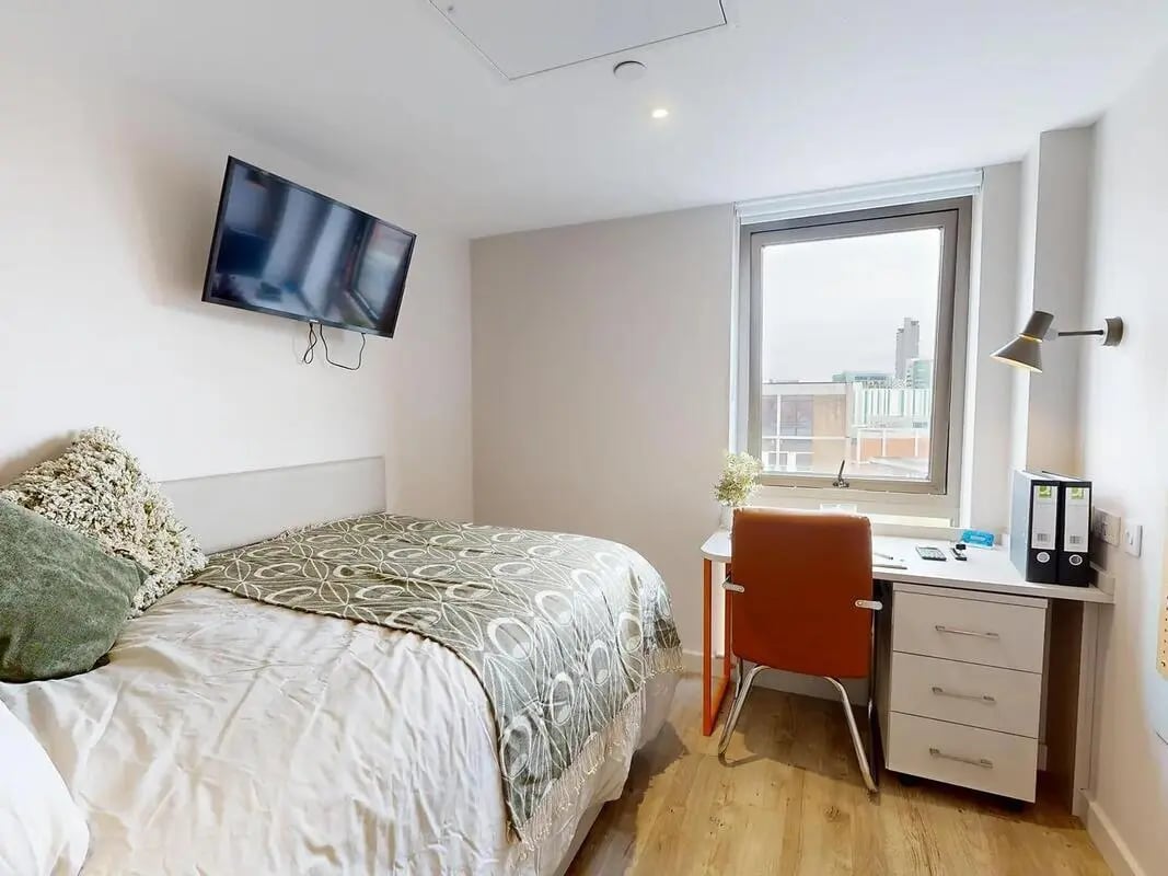 Bed desk and TV in modern student room at COSMOS in Sheffield Student Accommodation
