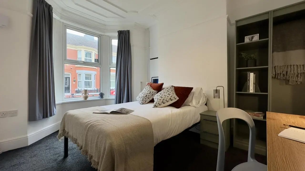 Bed with pillows and blanket plus desk bedroom at 4 Bedroom House at 126, Empress Road in Liverpool Student Accommodation