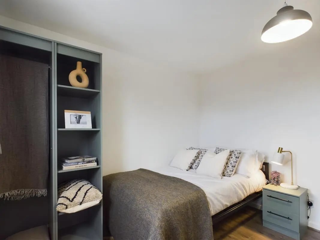 Bed pillows lamp bookshelf and blanket bedroom at 6 Bedroom House at 2, Flat 3, Windsor House, Clint Road West in Liverpool Student Accommodation