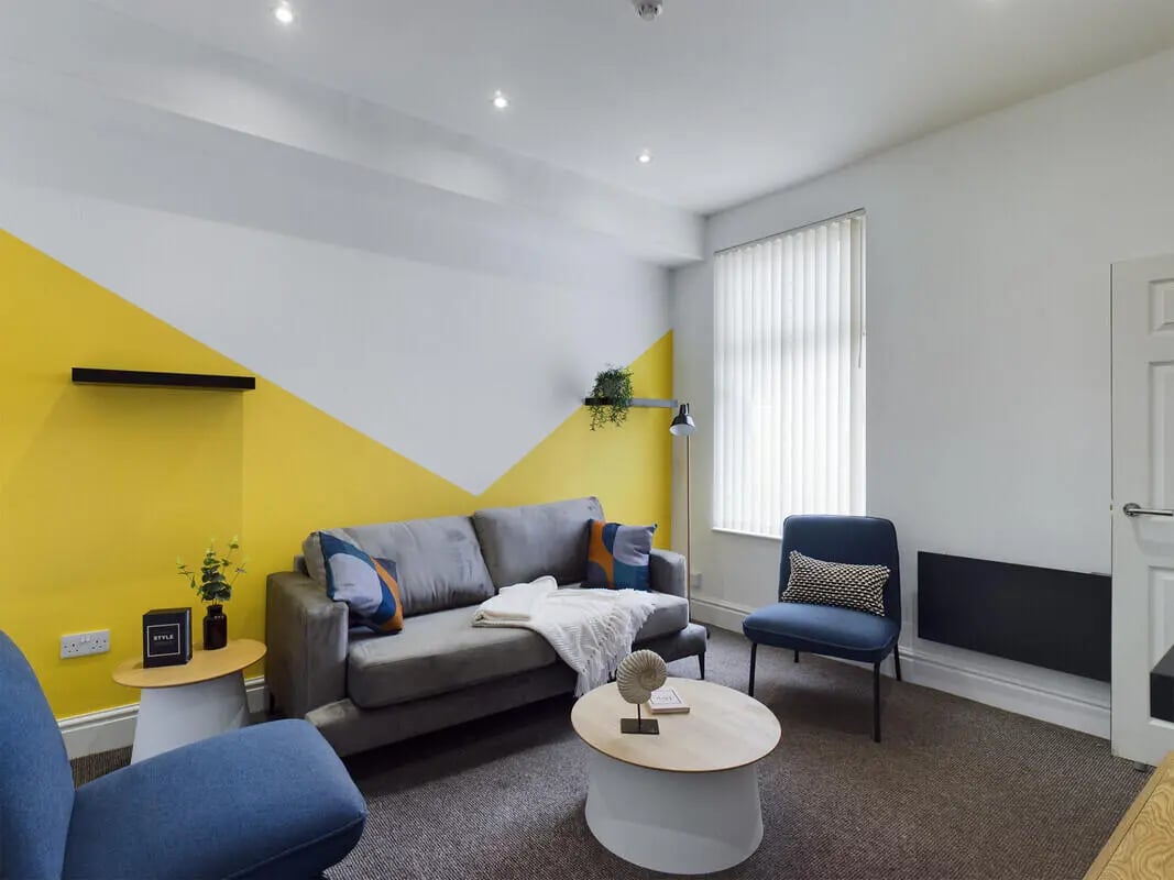 Grey sofa, blue chairs, coffee table living room at 4 Bedroom House at 107, Hall Lane in Liverpool Student Accommodation