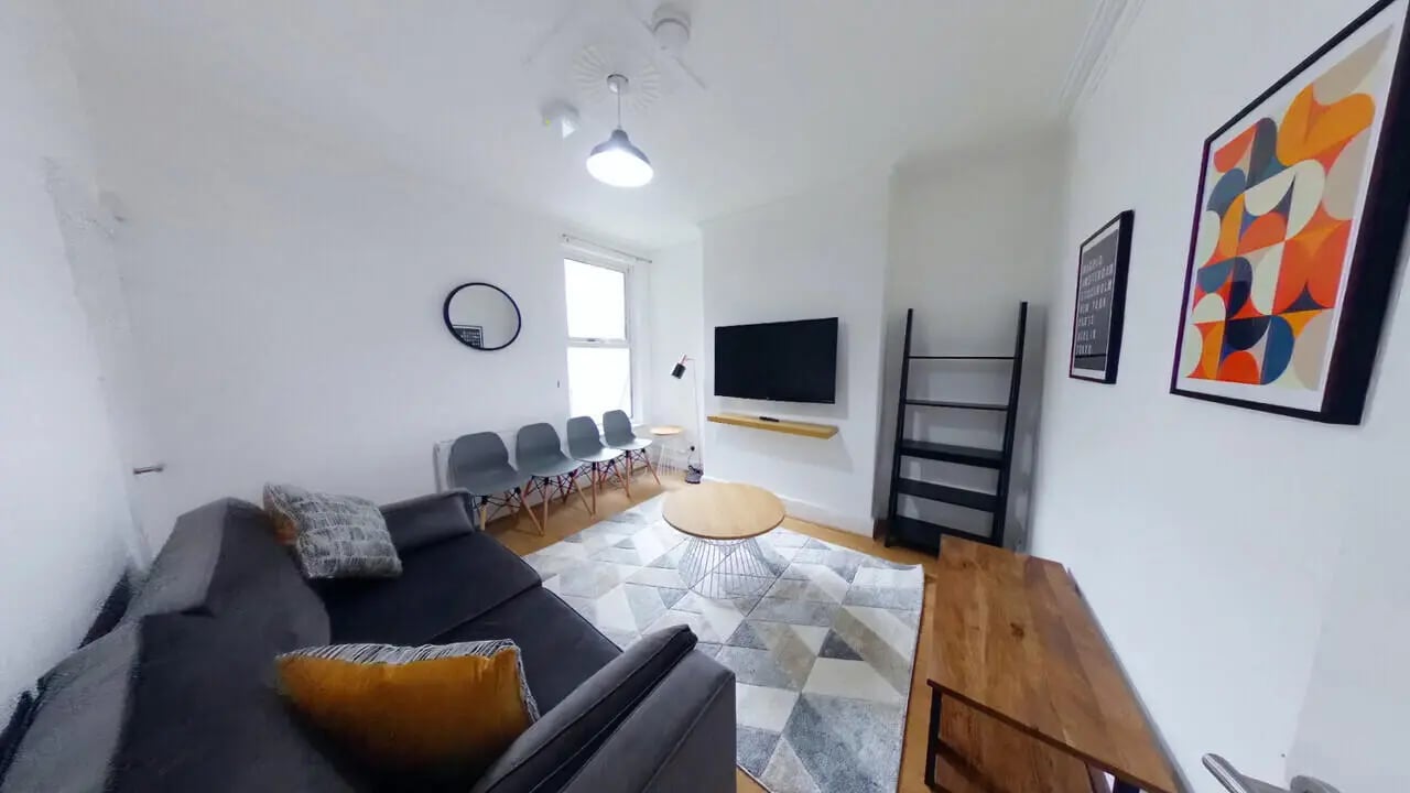 Sofa TV shelves chairs rug living room at 4 Bedroom House at 120, Adelaide Road in Liverpool Student Accommodation