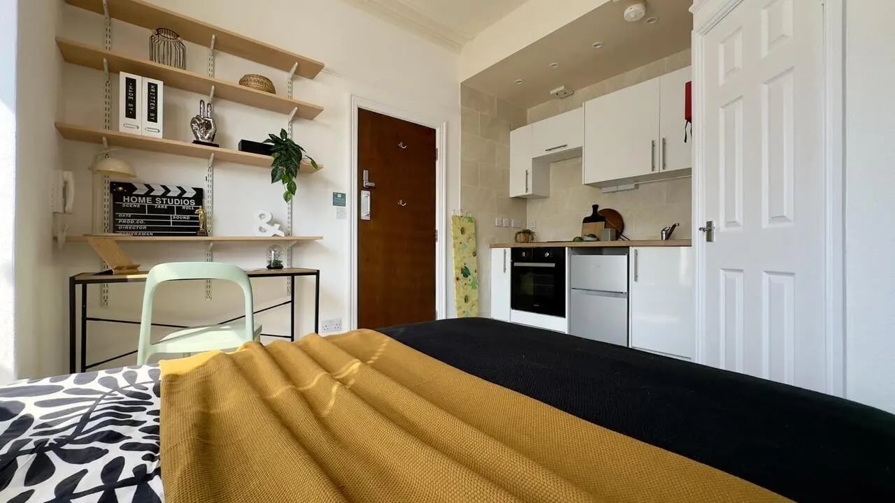 Studio apartment with bed kitchenette and shelves at 6 Bedroom House at 12, Studios at, Richmond Road in Lincoln Student Accommodation