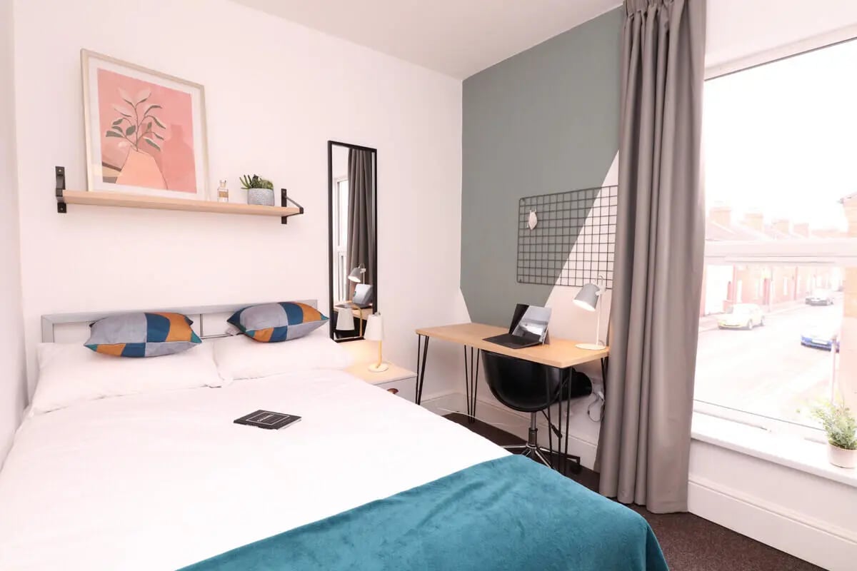 Bed desk art mirror and window bedroom at 6 Bedroom House at 232, West Parade in Lincoln Student Accommodation
