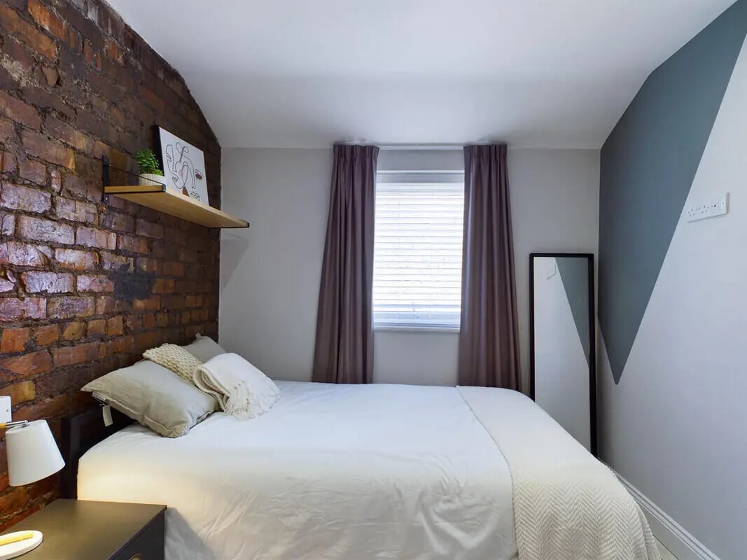 Bed with pillows and shelf bedroom at 7 Bedroom House at 4, Well Meadow Drive in Sheffield Student Accommodation