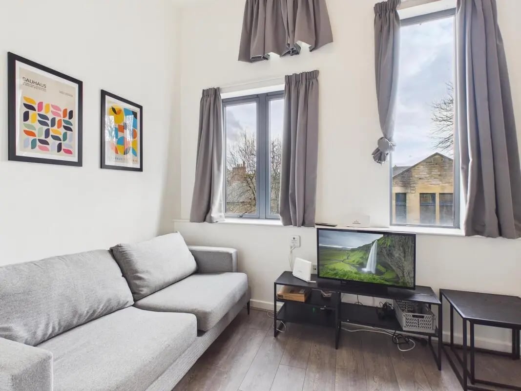 Gray sofa framed art television living room at 3 Bedroom House at Flat 3, 18, China Street in Lancaster Student Accommodation