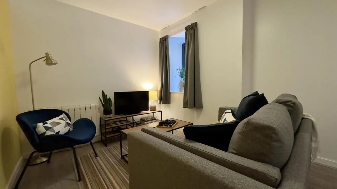 Sofa chair TV table plant lamp window living room at 4 Bedroom House at Flat 8, 18, China Street in Lancaster Student Accommodation