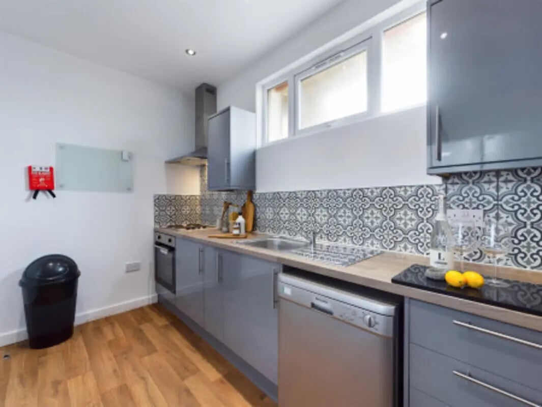 Grey cabinets dishwasher sink fire blanket kitchen at 9 Bedroom House at 128, Uttoxeter New Road in Derby Student Accommodation