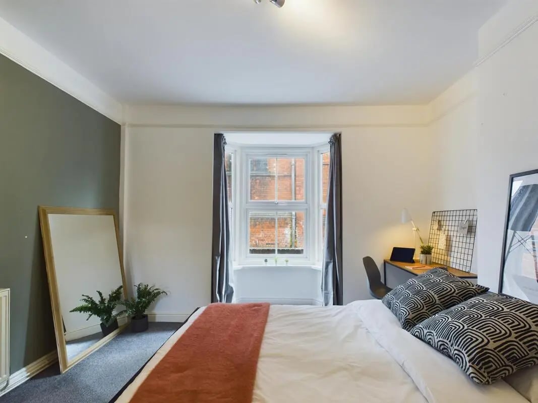 Bed mirror plants desk and chair bedroom at 4 Bedroom House at 11, Charles Street West in Lincoln Student Accommodation
