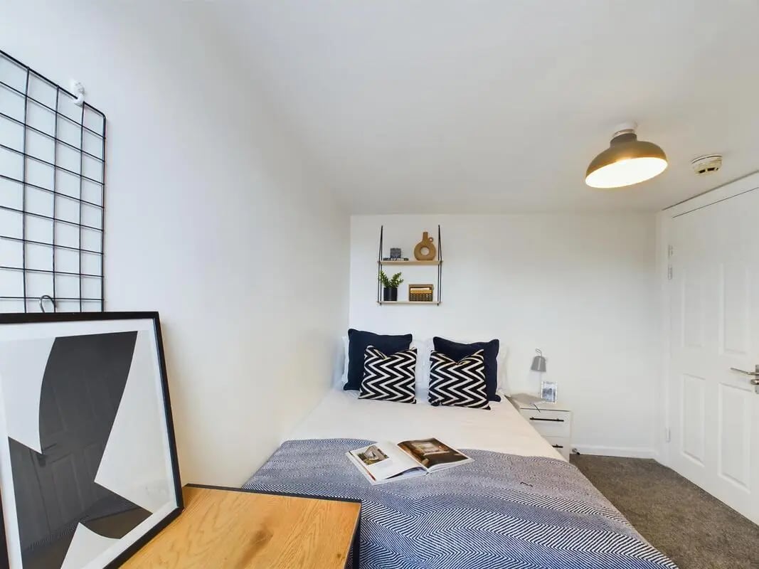 Bed pillows artwork metal shelf nightstand bedroom at 7 Bedroom House at 6, KIPPAX STREET in Manchester Student Accommodation