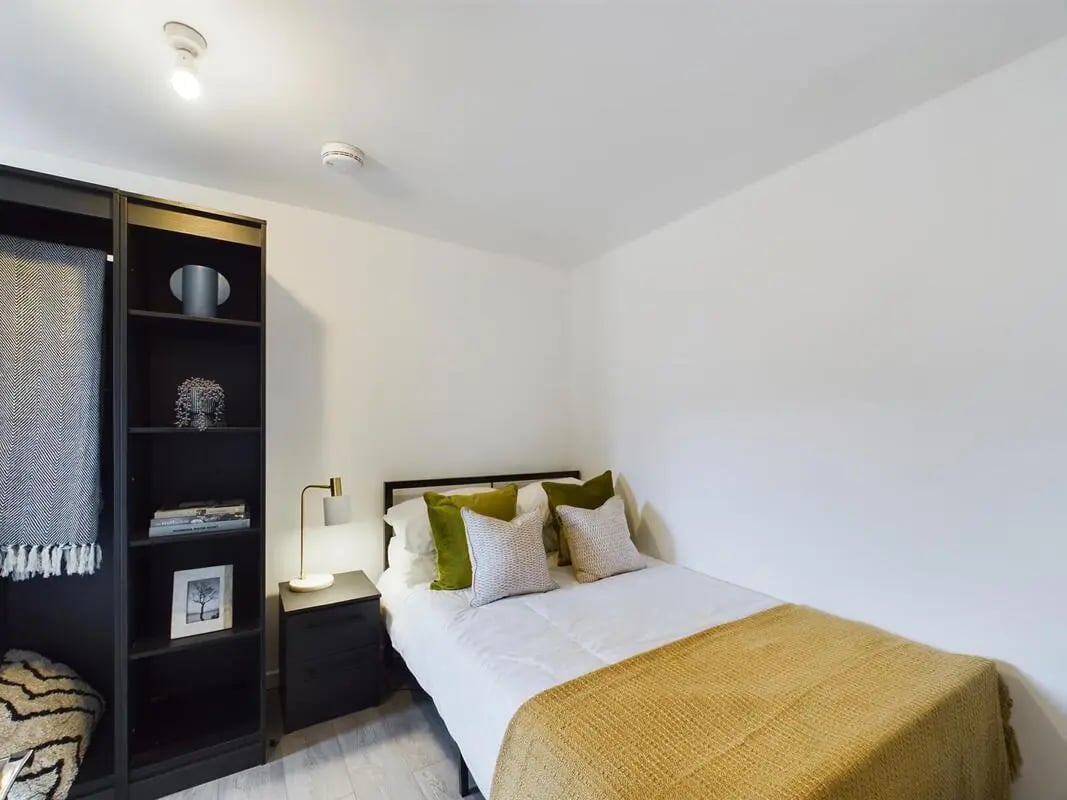 Bed desk lamp bookshelf pillows blanket bedroom at 4 Bedroom House at Flat 1, 58, Ruskin Avenue in Manchester Student Accommodation