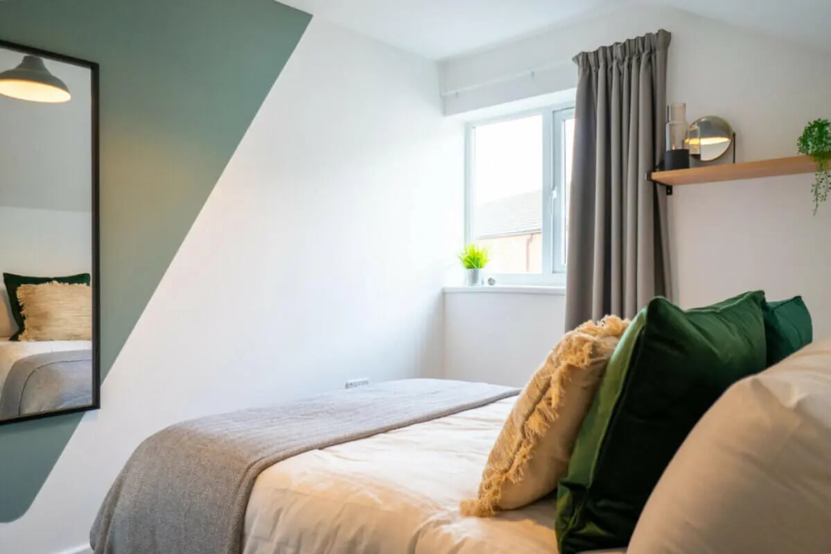 Bed pillows mirror window shelf bedroom at 6 Bedroom House at 5, ASHFIELD ROAD in Manchester Student Accommodation