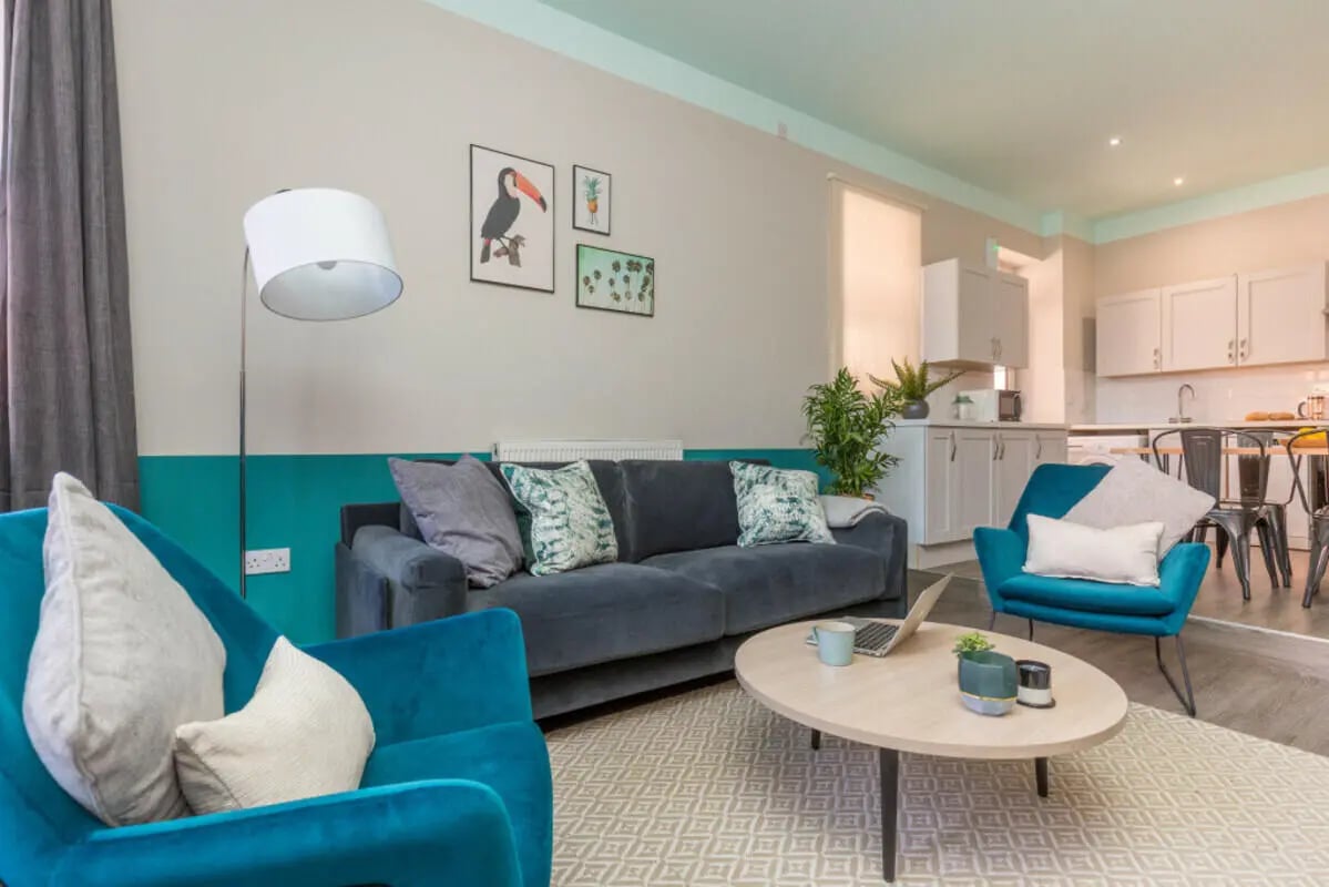 Sofa armchair coffee table kitchen living room at 5 Bedroom House at 64, Monson Street in Lincoln Student Accommodation