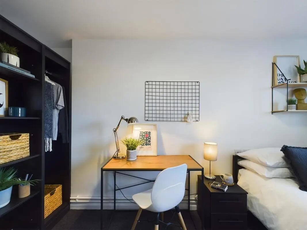 Desk lamp plants framed art white chair bedroom study area at 6 Bedroom House at 3, Brookside in Derby Student Accommodation